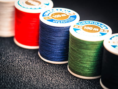 five 100 m assorted-color Obergarn sewing machine threads close-up photography thumbnail