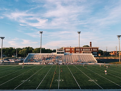 players playing on soccer stadium during day time thumbnail