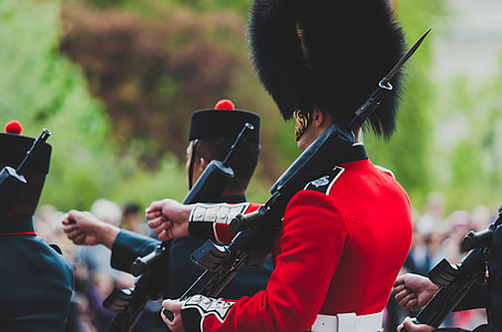 army holding rifle in red uniform thumbnail
