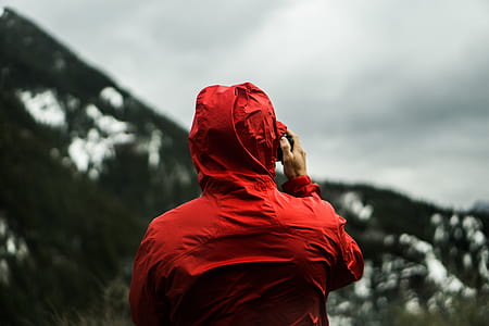 selective focus photography of person wearing red hooded jacket thumbnail