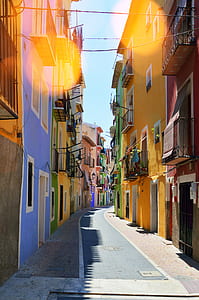 narrow road between colorful houses thumbnail
