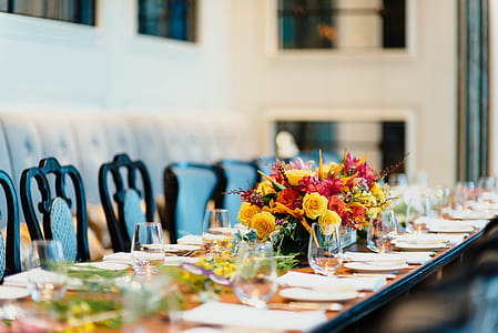 plates and flowers on long table thumbnail