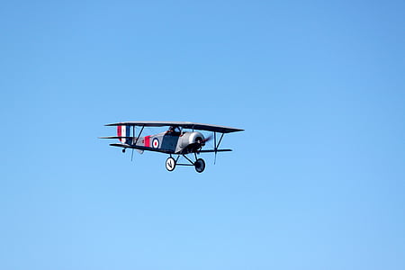 flying gray bi-plane thumbnail