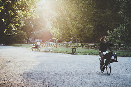 woman riding bike at the park during day thumbnail