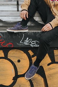 person wearing pair of purple low-top sneakers thumbnail