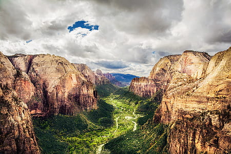 green forest between rock mountains thumbnail