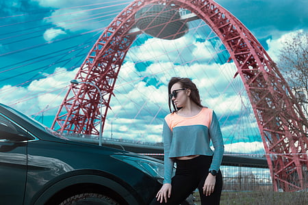 woman standing beside black vehicle thumbnail