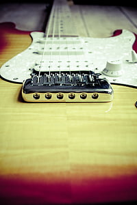 shallow focus photography of brown electric guitar thumbnail