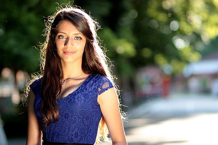 shallow focus photography of woman in blue short-sleeved top thumbnail