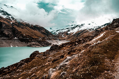 calm body of water in between of mountain thumbnail