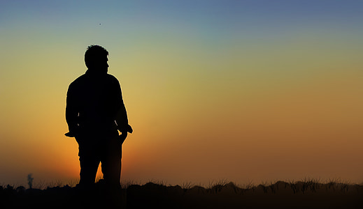 silhouette man standing on field thumbnail