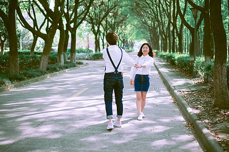 man holding hand of girl on road thumbnail