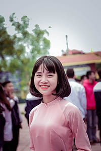 Photography of a Woman in Pink Long-sleeved Top Smiling thumbnail