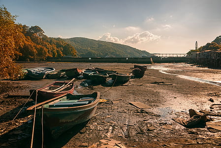 parked wooden boat on brown sand at daytime thumbnail