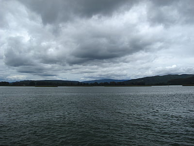 calm body of water under white clouds at daytime thumbnail