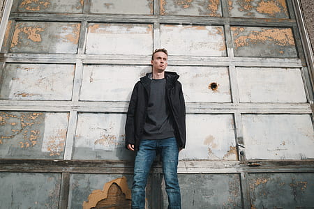 man standing in front wall thumbnail