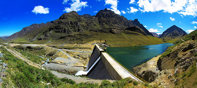 concrete dam surrounded with mountain range thumbnail