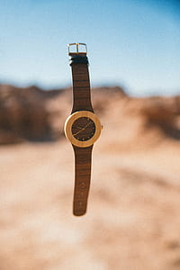 round brown analog watch with strap thumbnail