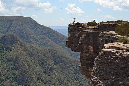 person on top of mountain near edge during day time thumbnail