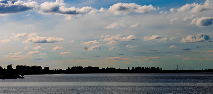 body of water under blue sky thumbnail