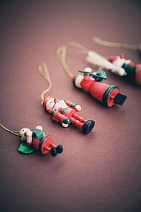 four Christmas decors on maroon surface thumbnail