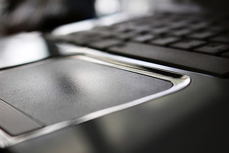 Close-up detail of a white laptop computer mouse pad thumbnail