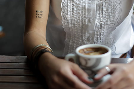 person holding white and gray ceramic coffee mug thumbnail