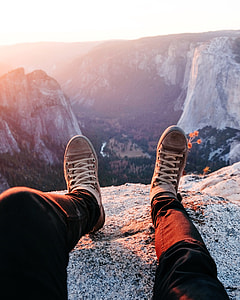 man wearing black pant at the top of mountain during sunrise thumbnail