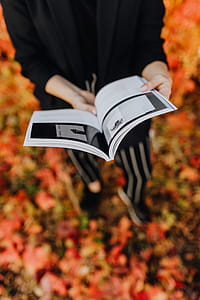 Girl with the Grafconf book on the background of colourful leaves thumbnail