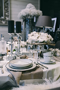 Fancy restaurant dinner table decorated with quail eggs and feathers thumbnail