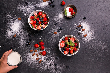 two bowls of strawberries and grapes thumbnail