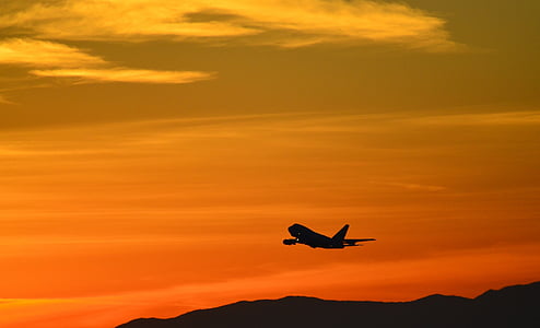 airplane taking off during sunset thumbnail