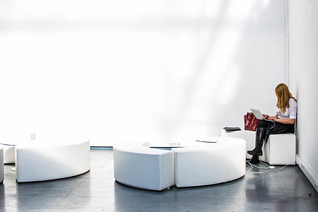 woman using laptop computer at corner of concrete structure thumbnail