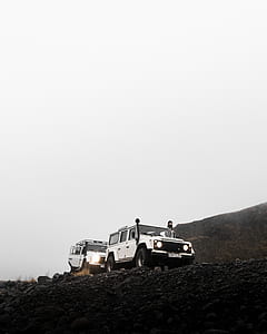 two vehicles on rock cliff thumbnail