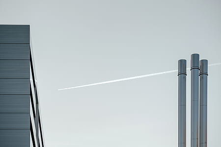 three grey pipes near jet plane thumbnail