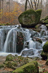 time lapse photography of waterfalls on moss covered rocks at daytime thumbnail