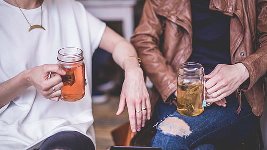 person holding clear Mason jar thumbnail