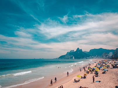 people on seashore under dark clouds thumbnail