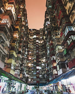 photography of white, red, and yellow concrete building during nighttime thumbnail