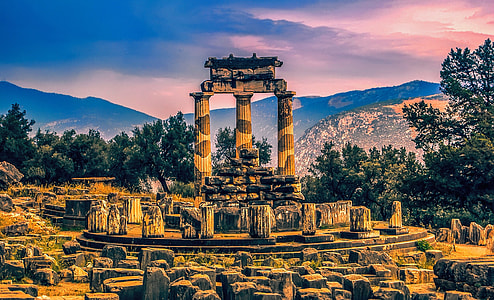 column ruins surrounded by trees and stone head thumbnail