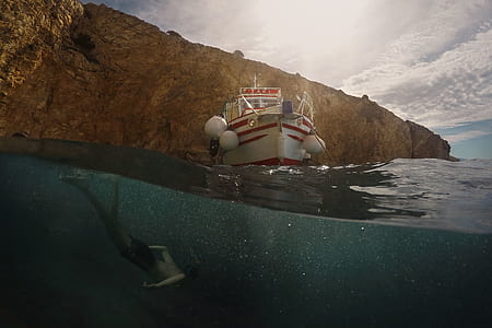 white and red boat on body of water thumbnail