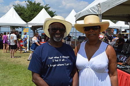 man and woman standing beside canopy tent thumbnail