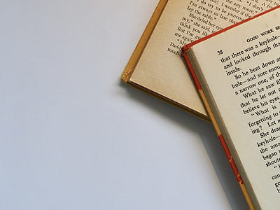 two books on white surface thumbnail