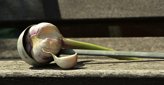 closeup photo of garlic on wooden board thumbnail