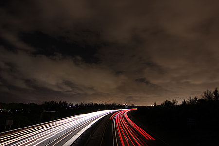 time lapse photography of cars running on a highway during night time thumbnail