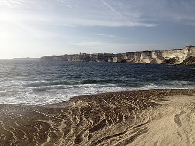 white cliff near body of water during daytime thumbnail