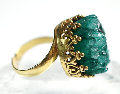 closeup photo of gold-colored ring with green gem thumbnail