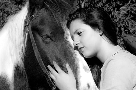 woman hugging horse outdoors thumbnail