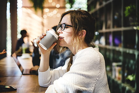 woman drinking coffee inside room thumbnail