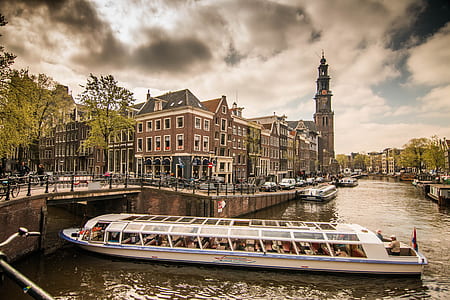 white passenger boat beside bridge thumbnail